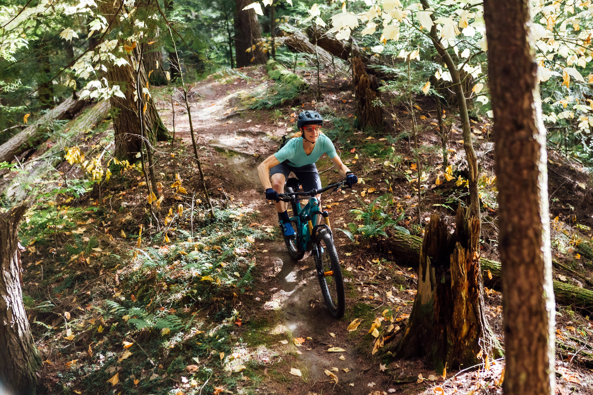 A lady shredding on a mountain bike trail
